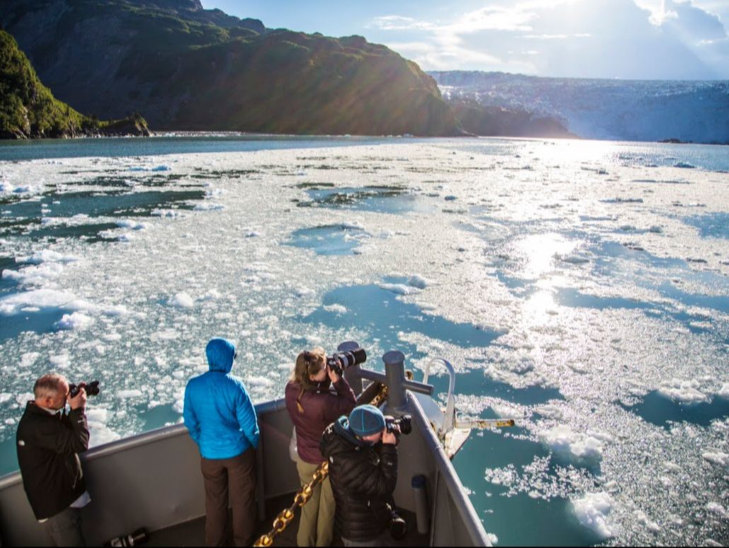 Guests photograph the bergy bits as the Island C cruises through icy waters of Nassau Fjord, Prince William Sound Alaska